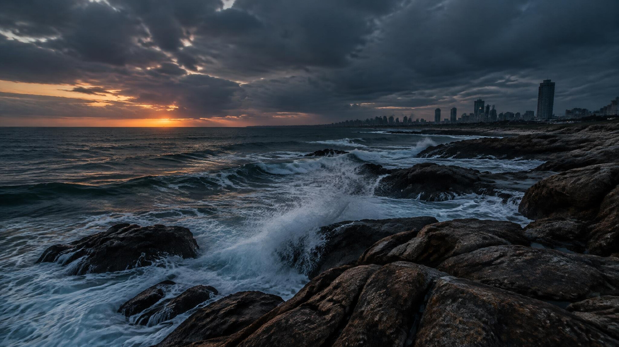 Coastal view of Punta del Este with rocky shoreline at dusk