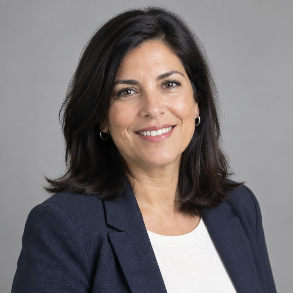 Studio portrait of a Uruguayan woman in her forties with dark hair, smiling professionally